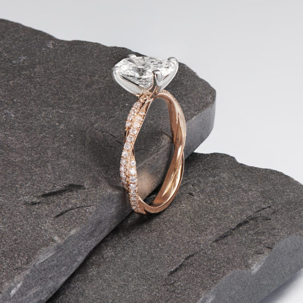 Twisted rose gold band with oval diamond